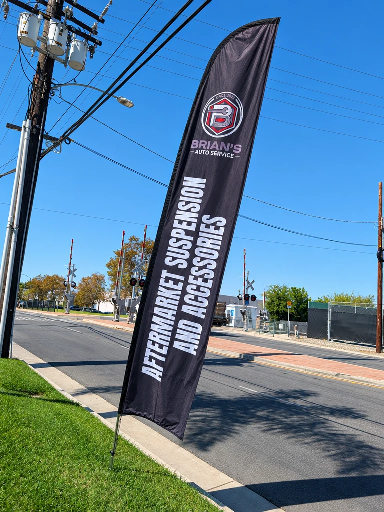 Aftermarket Suspension and Accessories flag outside Brian's Auto Service in Anaheim
