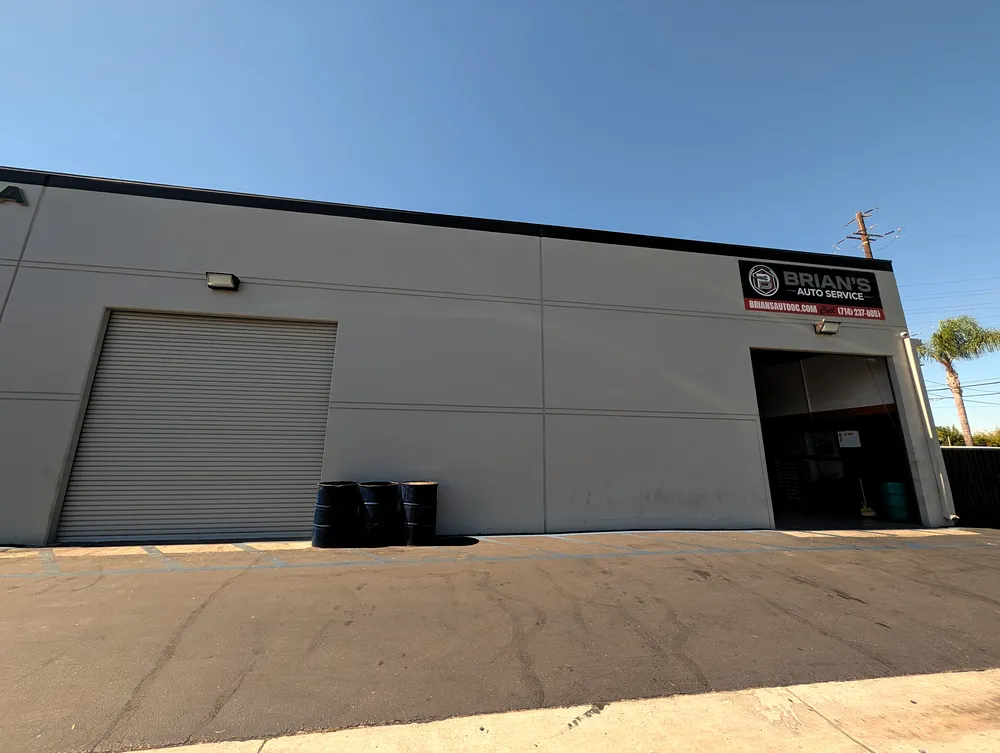 Side of the Brian's Auto Service building with roll-up door and second bay
