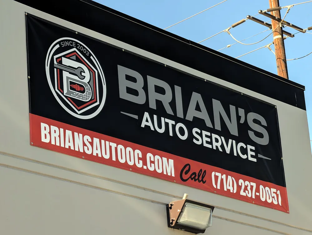 Brian's Auto Service sign with logo, website and phone number